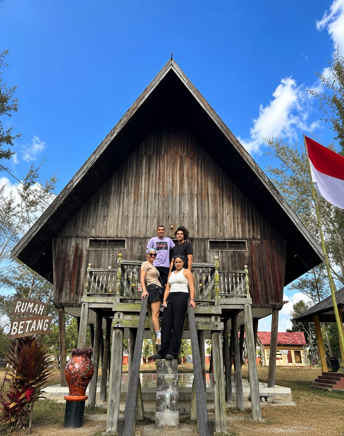 Guests exploring the traditional Dayak longhouse at Rumah Betang cultural village.