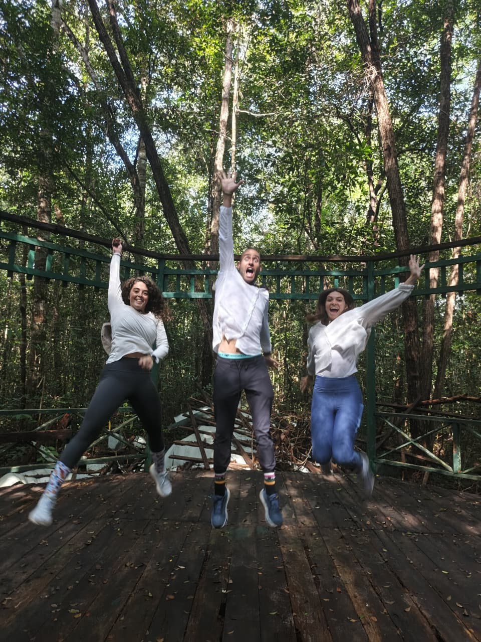 Pure joy - guests jumping on a wooden bridge deep inside the Tanjung Puting rainforest.
