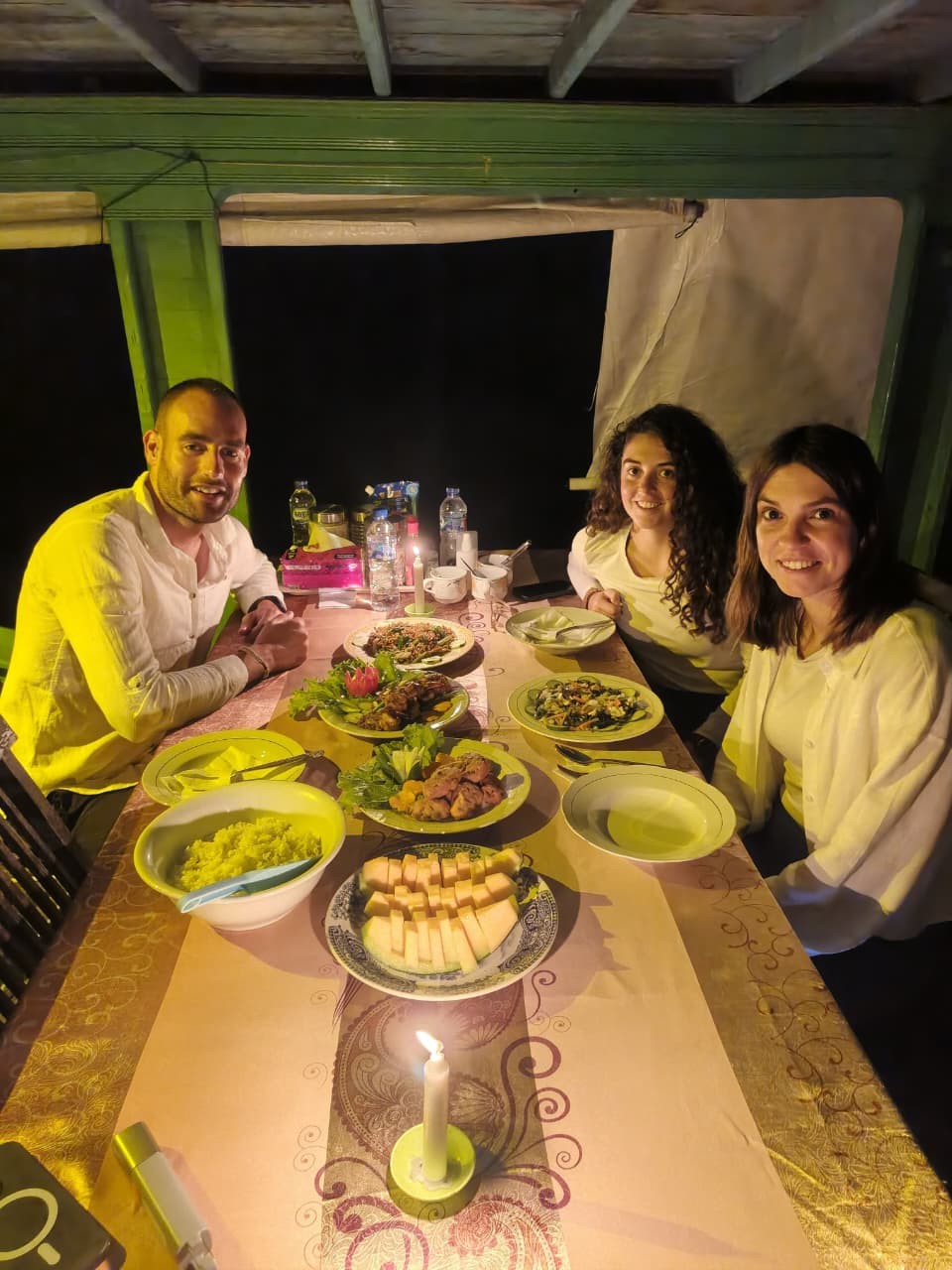 Romantic dinner by candlelight on the klotok with a full Indonesian spread served at night.