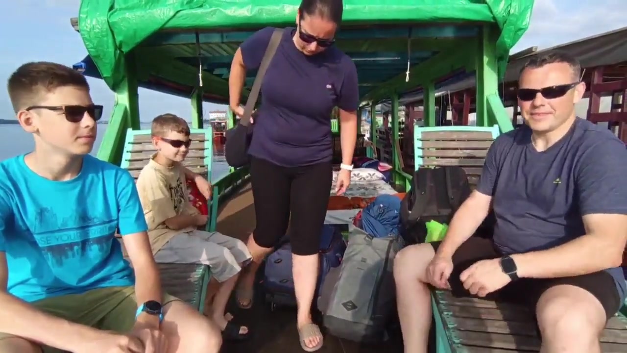 Family settling in and boarding the traditional klotok at Kumai harbour to start their river adventure.