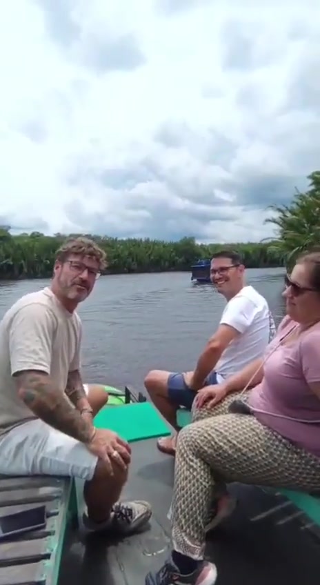 Three guests relaxing together on the klotok front deck while cruising the Sekonyer River.